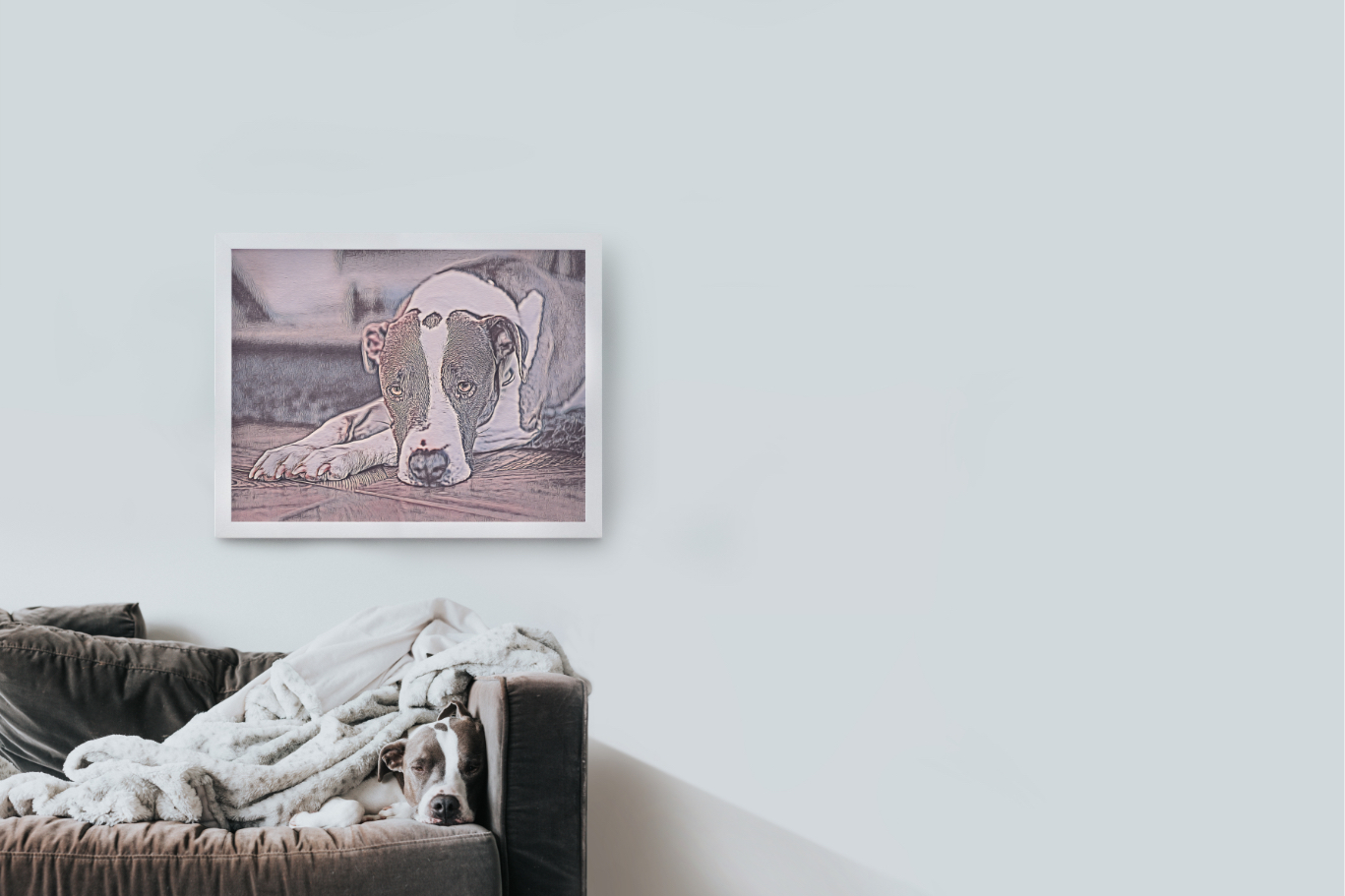 dog sleeping on couch underneath a pet portrait